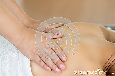 Closeup womans upper back with hands working on Stock Photo