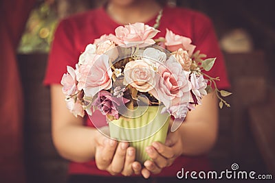 Closeup women hand hold rose flower love blossom. Stock Photo