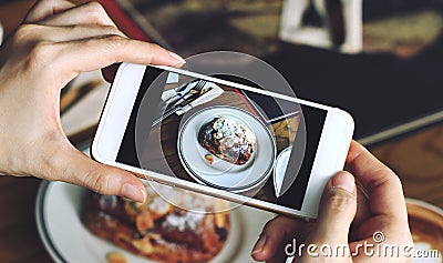 Closeup of women`s hands taking photo of sweet dessert by smartphone Stock Photo