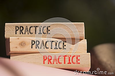 Closeup on wooden blocks placed on table with text PRACTICE, PRACTICE, PRACTICE, business concept image with soft focus background Stock Photo