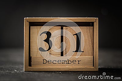 Closeup of the wooden calendar of blocks with the date of December 31 on the black background Stock Photo