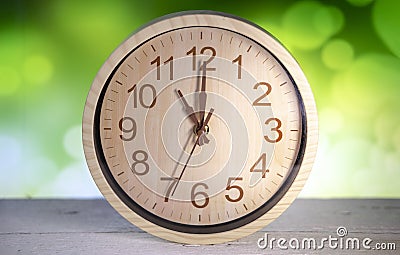 Closeup wooden wall clock show almost ten o`clock Stock Photo