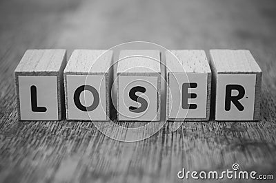 Wooden word on wooden table background concept - Loser Stock Photo