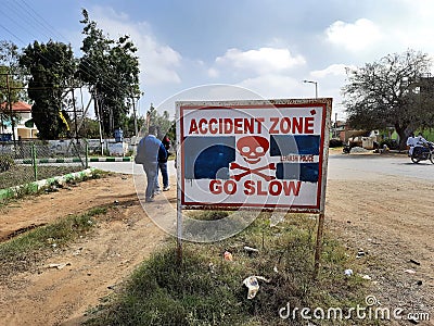 Closeup of written traffic sign in a board as a Accident zone go slow with danger symbol by lepakshi police station Editorial Stock Photo