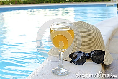 Closeup of yellow straw hat and black protective sunglasses, goggles, fresh orange juice smoothie drink cocktail on Stock Photo