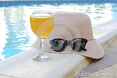 Closeup of yellow straw hat and black protective sunglasses, goggles, fresh orange juice smoothie drink cocktail on Stock Photo