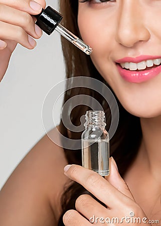 Closeup young ardent woman with healthy holding cbd oil and dropper. Stock Photo