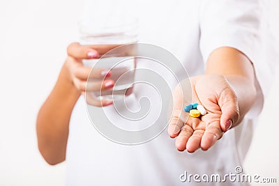 Woman hold pill drugs in hand ready take medicines with a glass of water Stock Photo