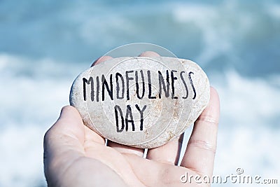 Man on the beach and text mindfulness day Stock Photo