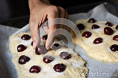 Preparing a coca de cireres, a cherry flat cake Stock Photo
