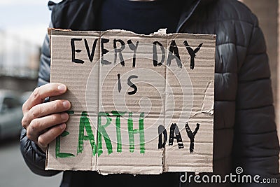 Text every day is Earth day in a brown signboard Stock Photo