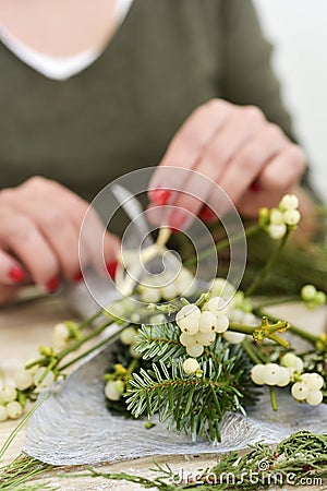 Woman arranging a bunch of mistletoe Stock Photo