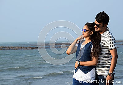 Closeup of a young couple enjoying the beauty of the sea. Romantic pose of Asian couple in honeymoon time Stock Photo