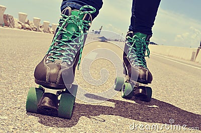 closeup of a young man roller skating, with a cross-processed effect Stock Photo