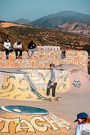 Closeup of a young man on a skateboard performing a trick on a ramp in Morocco Editorial Stock Photo