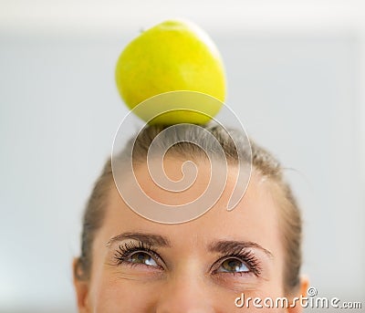 Closeup on young woman with apple on head Stock Photo