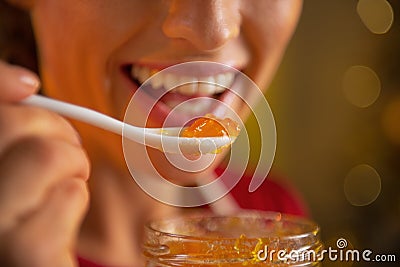 Closeup on young woman eating homemade orange jam Stock Photo