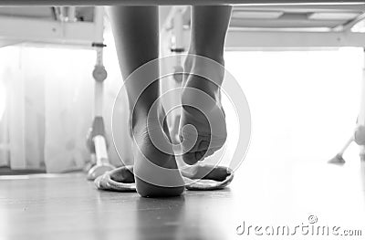 Black and white closeup photo of from under the bed on woman wearing slippers Stock Photo