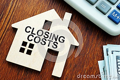 Closing costs. Model of house and money Stock Photo