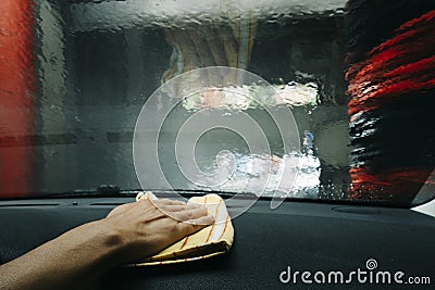 Man dusting the dashboard of a car Stock Photo