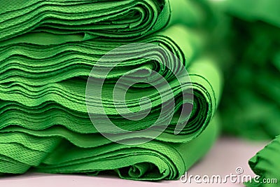 Cloth sports mesh folded into a stack of bright green color close-up. Stock Photo
