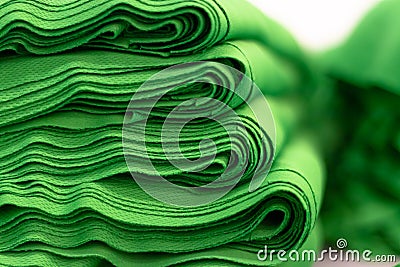 Cloth sports mesh folded into a stack of bright green color close-up. Stock Photo
