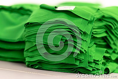 Cloth sports mesh folded into a stack of bright green color close-up. Stock Photo