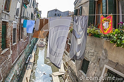 Clothes on a clothesline in a narrow street in Venice Editorial Stock Photo