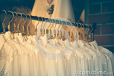 Clothes fashion on hangers at clothing store. with vintage filter. Stock Photo