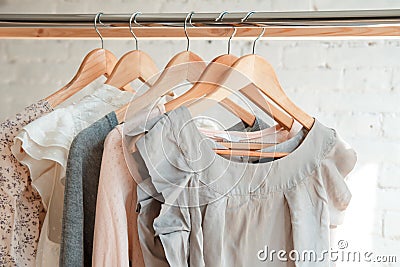 Clothes hang on clothing rack Stock Photo