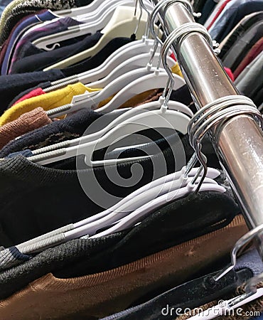 clothes hanging on hangers in used clothing store Stock Photo