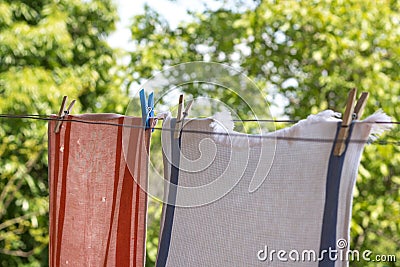 Clothes hanging up with pegs outside. Stock Photo
