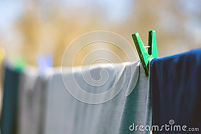 Clothes hitched with clothespins weigh on a rope Stock Photo