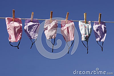 Clothes line full of face masks Stock Photo