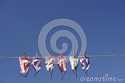 Clothes line full of face masks Stock Photo
