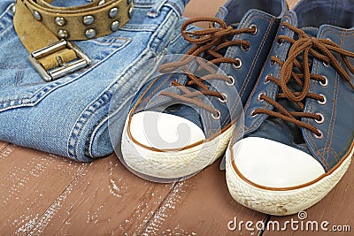 Clothes, shoes and accessories - Closeup belt, gumshoes and blue Stock Photo