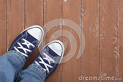 Clothes, shoes and accessories - legs put in gumshoes and blue j Stock Photo