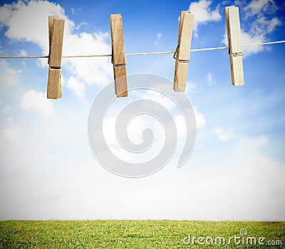 Clothespin on a laundry line outside with bright blue sky Stock Photo