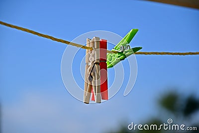 Clothespins in blue sky, white and red green colors Stock Photo