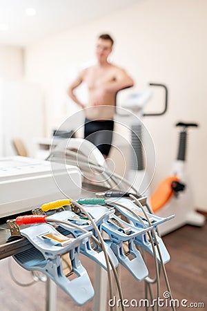 Clothespins of the ECG machine in the foreground. Athlete does a cardiac stress test and VO2 in a medical study Stock Photo