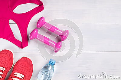 Clothing and dumbbells with water for sports, place for inscription Stock Photo