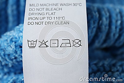 Clothing label with care symbols on sweater, closeup view Editorial Stock Photo