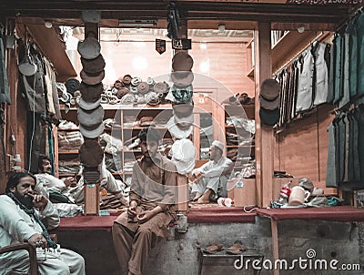 Clothing shop with traditional clothes and male sellers in it, Peshawar, Pakistan Editorial Stock Photo