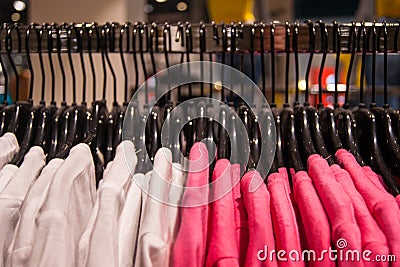 Clothing store. Bright things hang neatly on the black shoulders Stock Photo