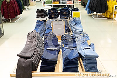 Clothing store with a large assortment of pants and jeans hanging on hanger Editorial Stock Photo