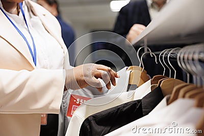 Clothing store worker restocking racks Stock Photo