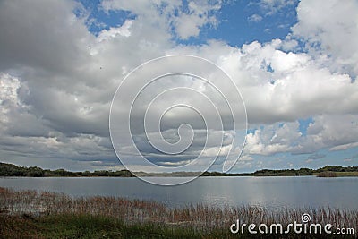 A cloud filled sky over a lake in Everglades National Park, FL. Stock Photo