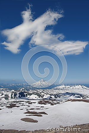 The cloud over Vilyuchinsky volcano shaped like a giant dragon, view from the slope of Gorely volcano, Kamchatka Peninsula Stock Photo