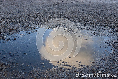 Cloud in puddle reflection gravel Stock Photo