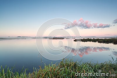 Cloud reflection in lake at sunrise Stock Photo